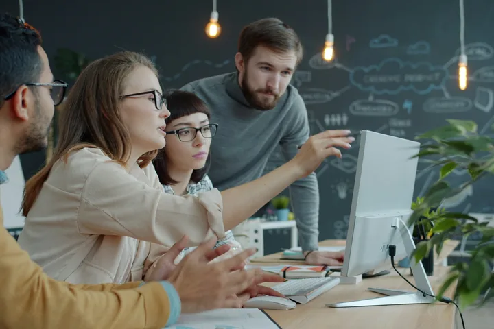 The Pakolo team working together at the screen